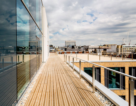 Treated softwood decking meets architectural aesthetics at mixed use development.